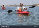 stock-photo-a-group-of-kayakers-riding-in-the-sea-85892554.jpg